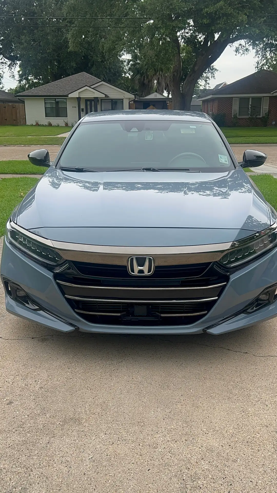 Glossy sedan paint reflecting light after machine polishing